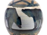 a blue and white vase with two bears on it