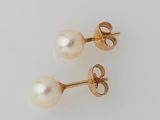 a pair of pearl and gold earrings