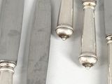 several knives are lined up next to each other on a white surface