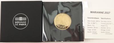 a gold medal in a black box on a white table