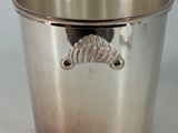 a silver cup with a mustache on it on a table