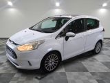 the white ford fiesta is parked in a large room