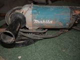 a small electric grinder sitting on a green surface