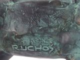 statue of a bull with a tag on it ' s side