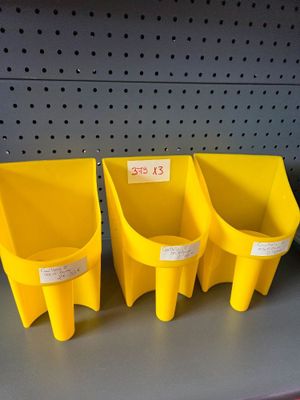three yellow plastic bins are on a shelf in a store