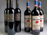 several bottles of wine are lined up on a table