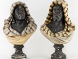 pair of busts of a man and a woman with scarves on their heads