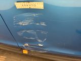 a sticker on the side of a blue car with a sticker on it