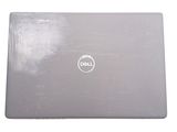 dell laptop computer sitting on top of a white surface on a white surface
