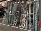 many metal ladders stacked up in a warehouse