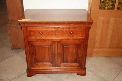 a small wooden cabinet with a drawer on top of it