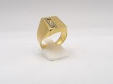 a close up of a gold ring on a white surface