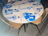 a table that has a bunch of chairs around it