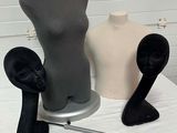 three mannequins sitting on a table with a pair of shoes on it