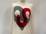 a white shirt with a red heart on it on a mannequin