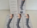 four pairs of socks in a box on a table