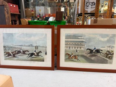 two framed pictures of horses and jockeys in a room