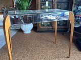 a desk with a glass top in a living room