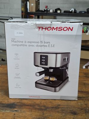boxed box of a coffee machine sitting on top of a wooden table