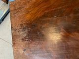 a piece of wood on the floor next to a chair