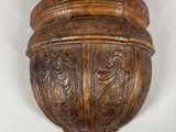 carved wood wall sconce in the shape of a bowl