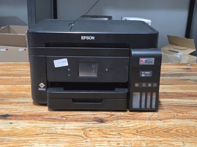 a printer that is sitting on a wooden table