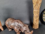 a small statue of an elephant next to two vases and a clock