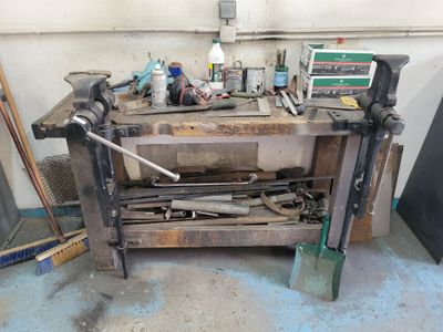 a workbench with tools on top of it in a garage