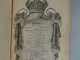 an open book with a picture of a crown on it