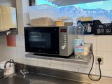 a kitchen with a sink and a microwave in it