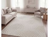 a white rug with waves on it in a living room
