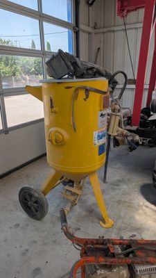 a yellow machine that is sitting in a garage