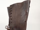 brown leather boots with laces on them sitting on top of a white surface