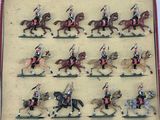 many figurines of soldiers riding horses in a display case
