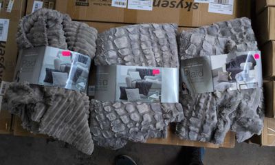 boxes of blankets are stacked on top of each other on a table