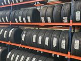 tires are stacked on shelves in a warehouse with shelves full of them