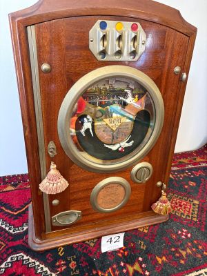 a wooden clock on a rug on the floor