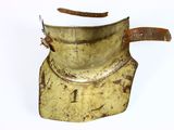 an old brass pot with a handle on a white surface