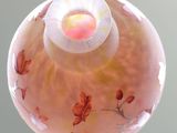 a glass ball with a flower design on it on a table