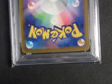 a close up of a pokemon card in a plastic case