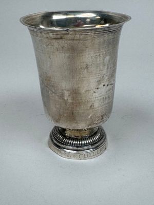 a silver cup that is sitting on top of a table