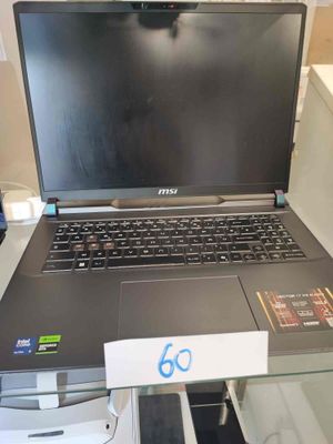 a laptop computer sitting on top of a glass table