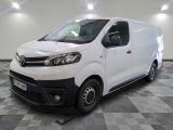 la camionnette blanche est garée sur un sol en damier dans le garage