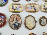 a lot of brooches and brooches on the table
