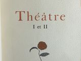 an old book with a rose on it sitting on a table