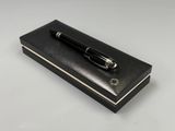 the pen is sitting on top of a black box