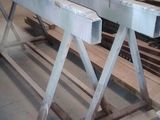 a picture of a table in a warehouse with a lot of wood