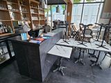 tables and chairs in a room with a bar and a window