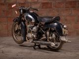 a motorcycle that is parked in front of a brick wall