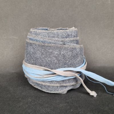 a stack of jeans wrapped in a blue ribbon